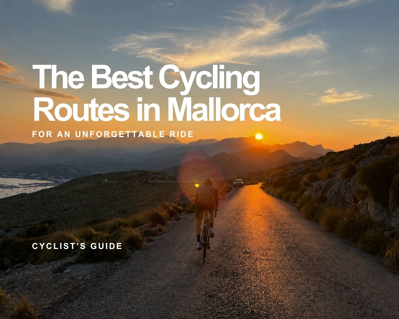 Cyclist riding along a scenic mountain road in Mallorca at sunset, with dramatic mountain views and golden light.